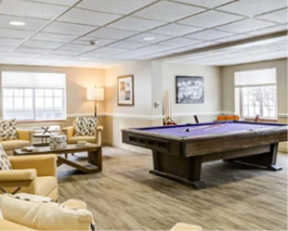 A pool table is in a living room with a couch and chair nearby. AI generated content