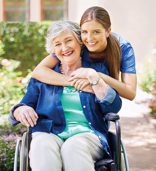 Shot of a resident and a nurse outside in the retirement home garden